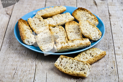 Image of Fresh italian croutons crostini on blue plate.