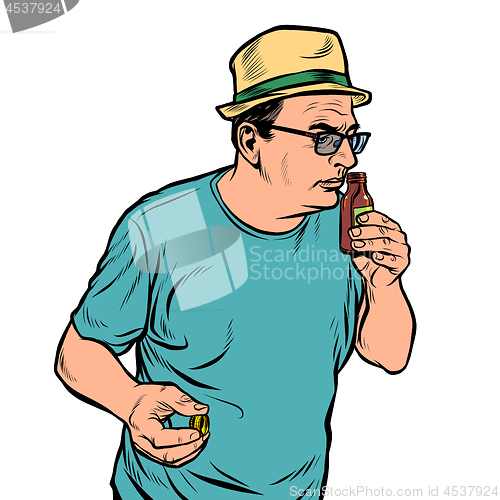 Image of a man sniffs a bottle. perfume or medicine