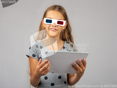 Image of The girl in the colored 3D glasses, made using the anaglyph technology of the 3D glasses, looked into the frame