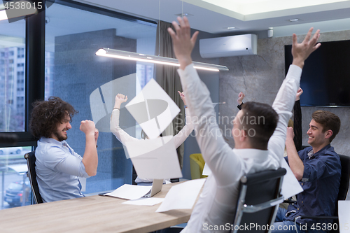 Image of startup Group of young business people throwing documents