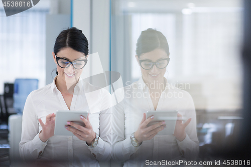 Image of Business Woman Using Digital Tablet in front of startup Office