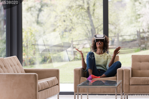 Image of black woman using VR headset glasses of virtual reality