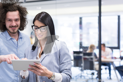 Image of Business People Working With Tablet in startup office