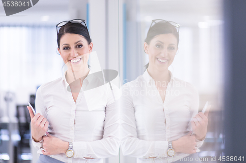 Image of Business Woman Using Digital Tablet in front of startup Office