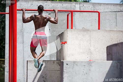 Image of Athlete doing exercises at stadium