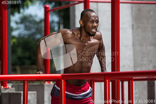 Image of Athlete doing exercises at stadium