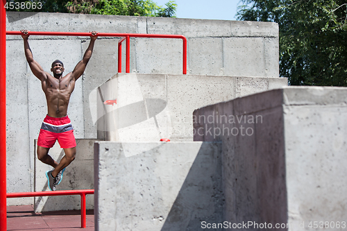 Image of Athlete doing exercises at stadium