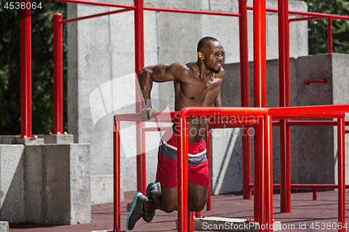 Image of Athlete doing exercises at stadium