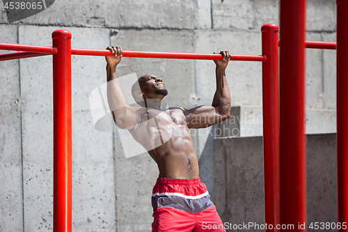 Image of Athlete doing exercises at stadium