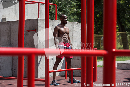 Image of Athlete doing exercises at stadium