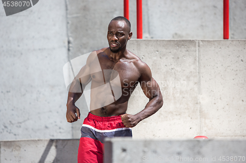 Image of Athlete doing exercises at stadium