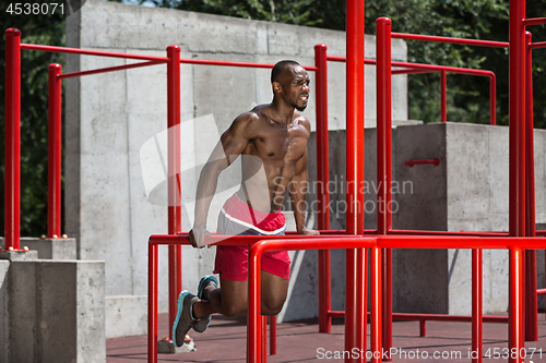 Image of Athlete doing exercises at stadium