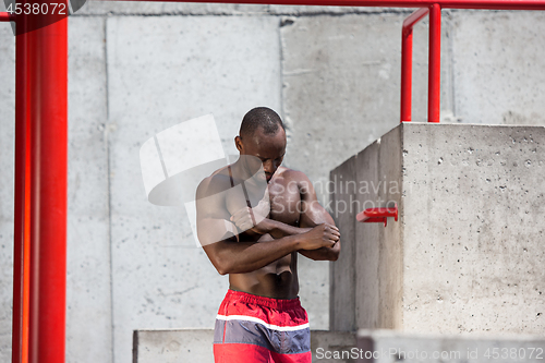 Image of Athlete doing exercises at stadium