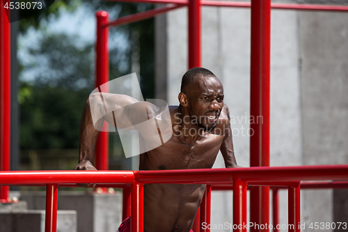 Image of Athlete doing exercises at stadium