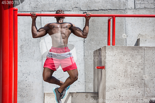 Image of Athlete doing exercises at stadium