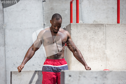 Image of Athlete doing exercises at stadium