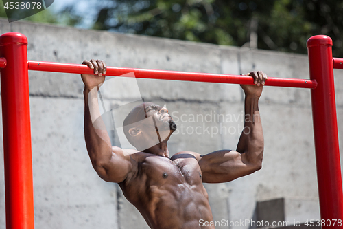 Image of Athlete doing exercises at stadium