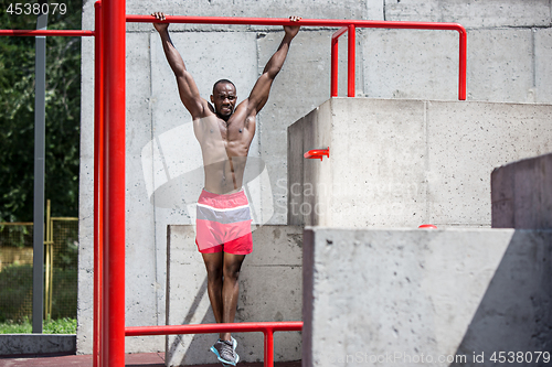 Image of Athlete doing exercises at stadium