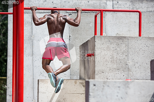 Image of Athlete doing exercises at stadium