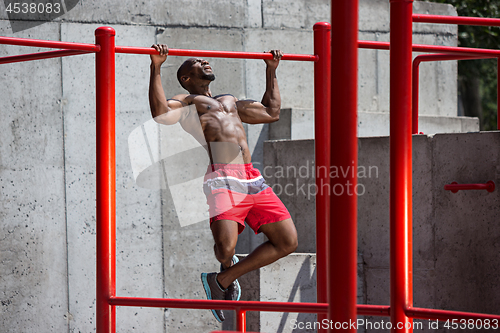 Image of Athlete doing exercises at stadium