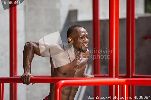 Image of Athlete doing exercises at stadium