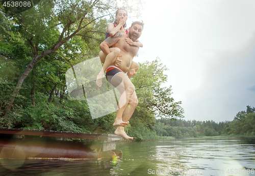 Image of Enjoying river party with friends. Group of beautiful happy young people at the river together