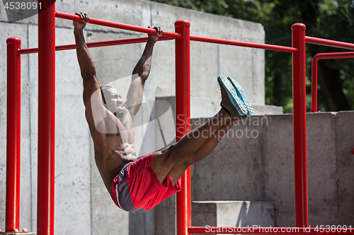 Image of Athlete doing exercises at stadium