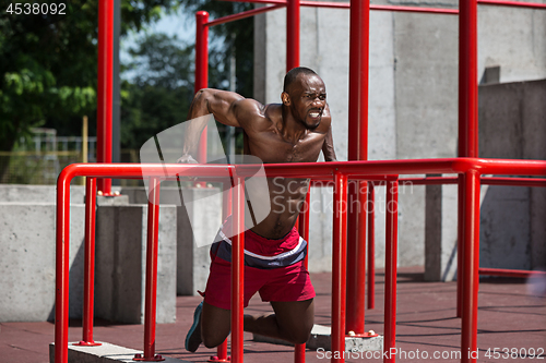 Image of Athlete doing exercises at stadium