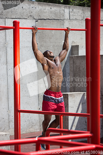 Image of Athlete doing exercises at stadium