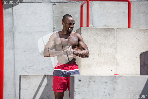 Image of Athlete doing exercises at stadium