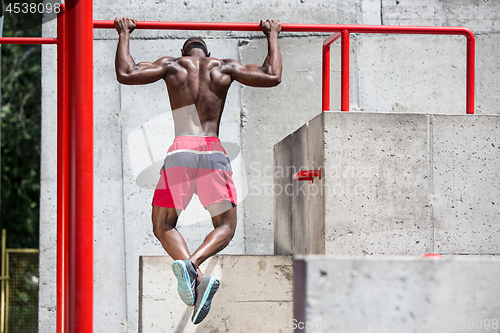 Image of Athlete doing exercises at stadium