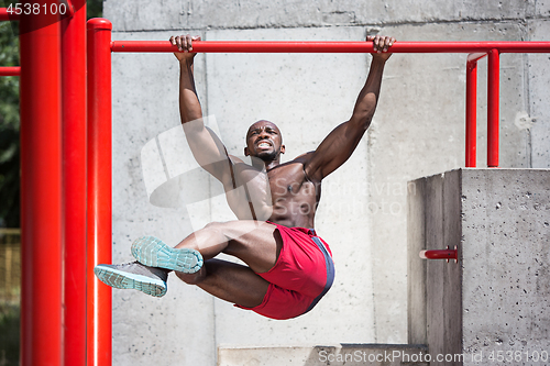 Image of Athlete doing exercises at stadium