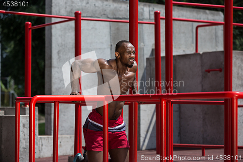 Image of Athlete doing exercises at stadium