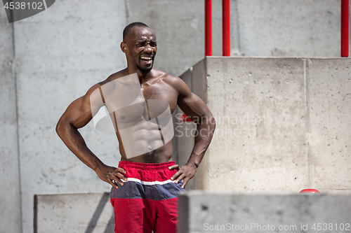 Image of Athlete doing exercises at stadium