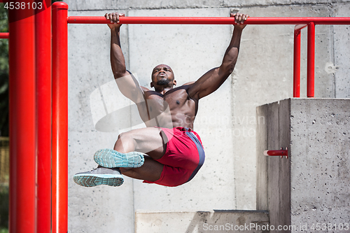Image of Athlete doing exercises at stadium