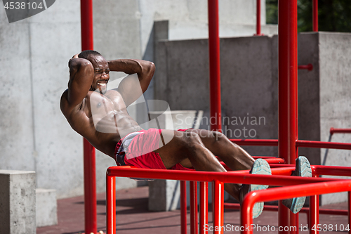 Image of Athlete doing exercises at stadium