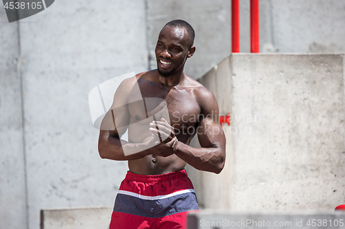 Image of Athlete doing exercises at stadium