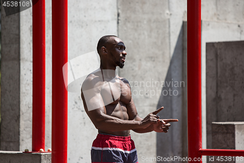 Image of Athlete doing exercises at stadium