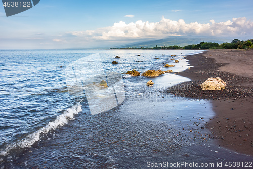 Image of a dark sand beach in northern Bali Indonesia