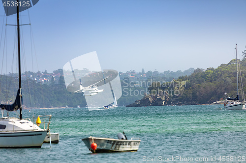 Image of plane flying over the ocean in Sydney Australia