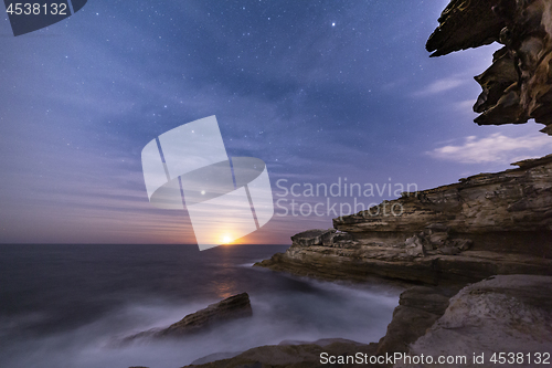 Image of Sydney coast by night with moon rise