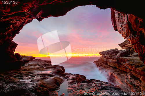 Image of Coastal cave views to glorious sunrise over the ocean