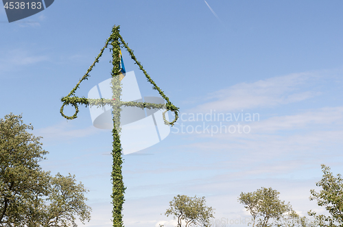 Image of Swedish maypole by a blue sky