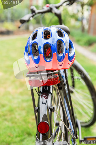 Image of Bicycle with bike helmet on the rack