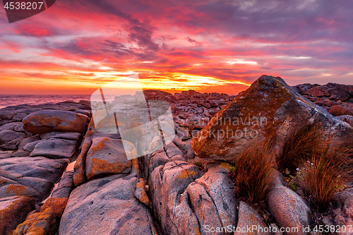 Image of Rich red sunrise over the rocky coast Australia