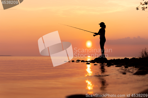 Image of Woman fishing on Fishing rod spinning in Norway.