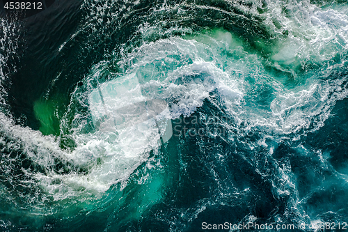 Image of Waves of water of the river and the sea meet each other during h