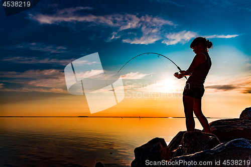 Image of Woman fishing on Fishing rod spinning in Norway.