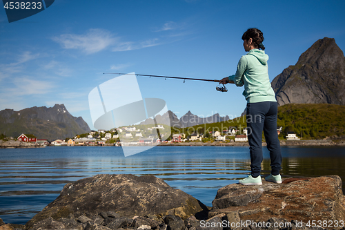 Image of Woman fishing on Fishing rod spinning in Norway.