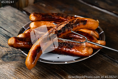 Image of Grilled sausages on wooden board